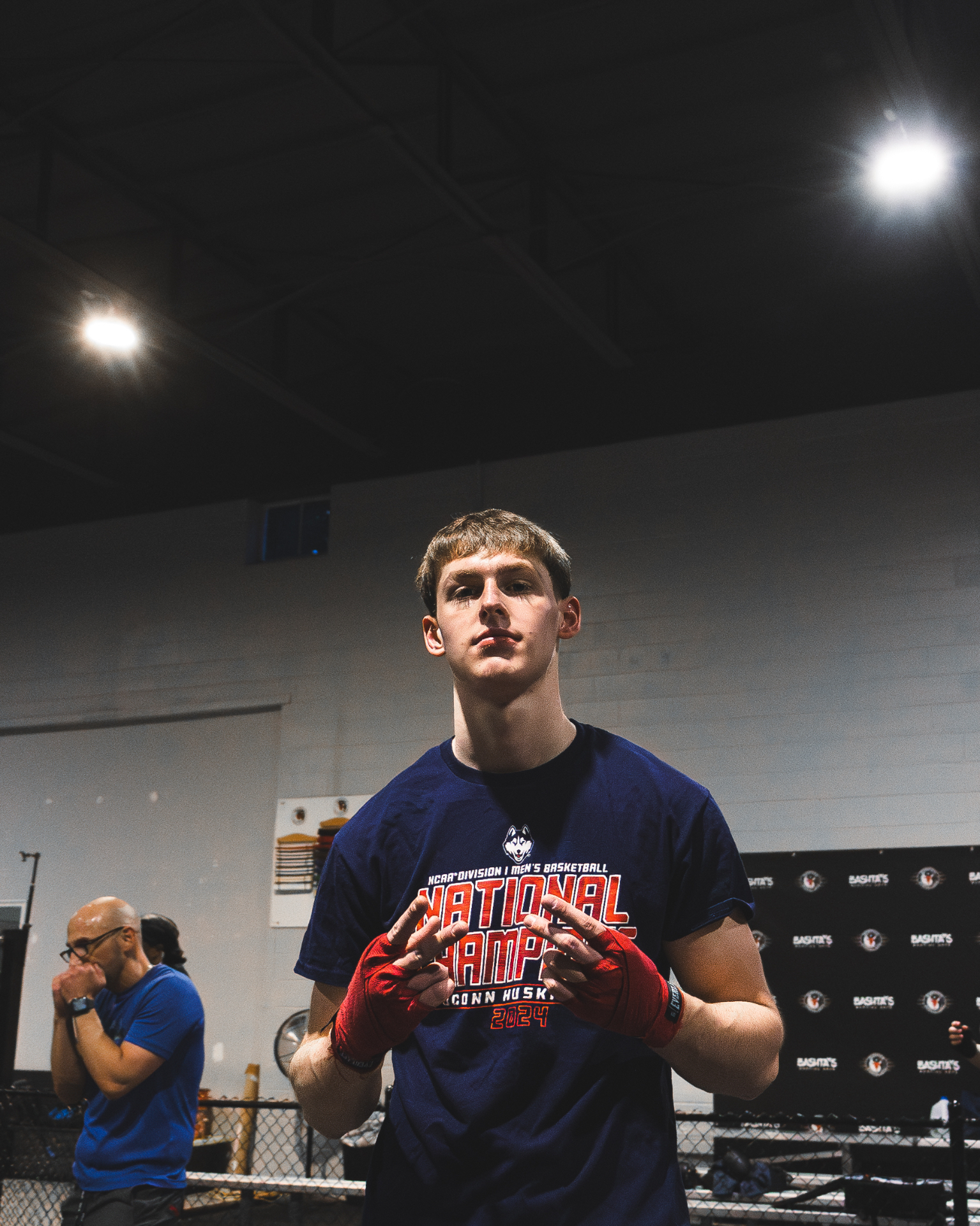 Young boxer with red hand wraps ready to train at Coach Josh Boxing