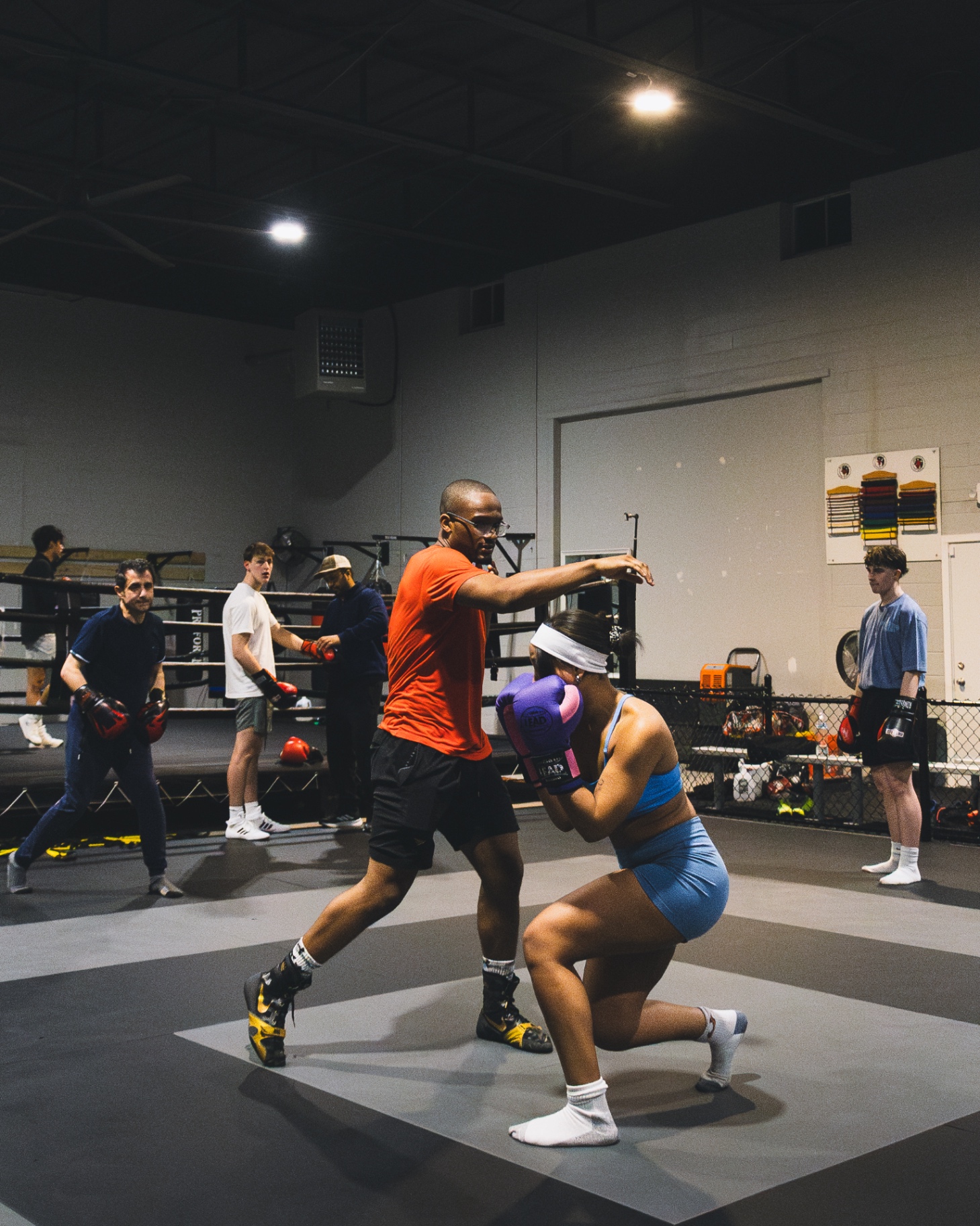 Coach Josh teaching pad work to a boxer in the Hamden, CT gym